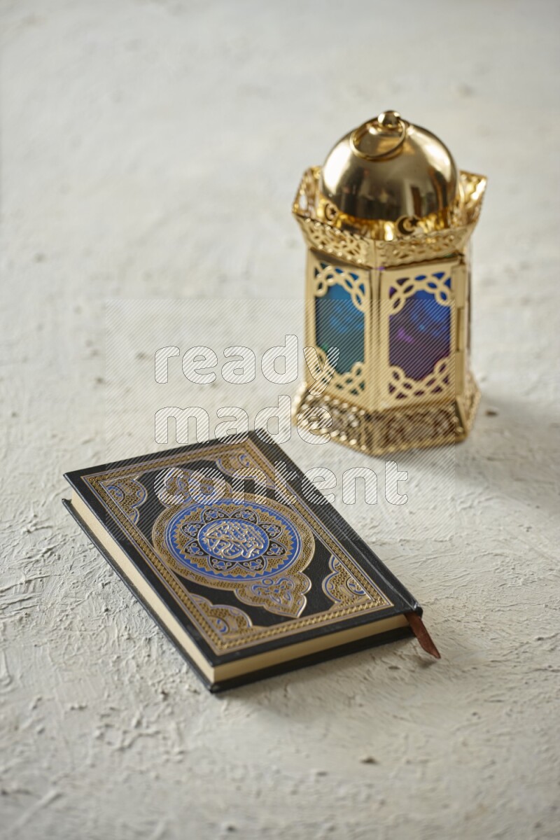 A golden lantern with different drinks, dates, nuts, prayer beads and quran on textured white background