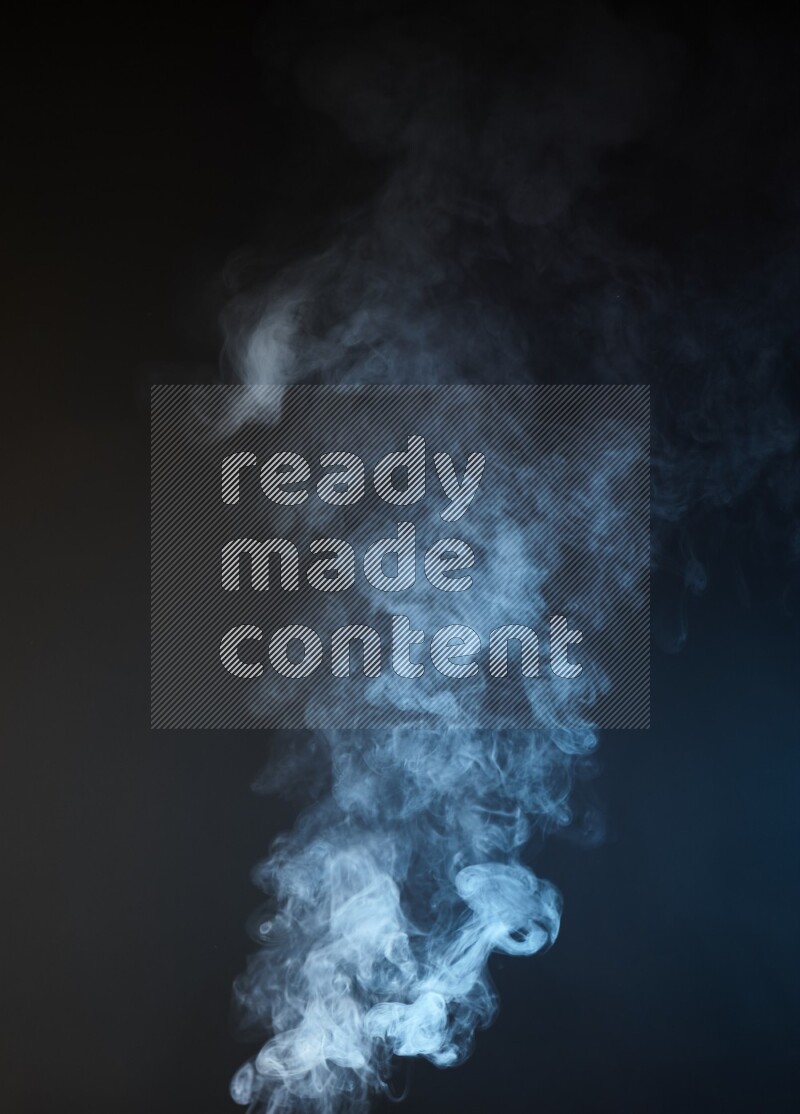 Heavy smoke in blue and yellow isolated on black background
