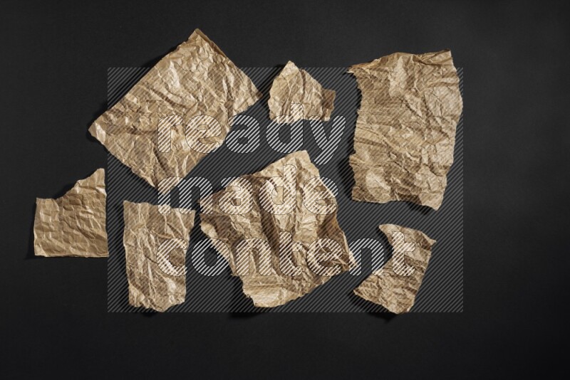 Crumpled craft paper on black background
