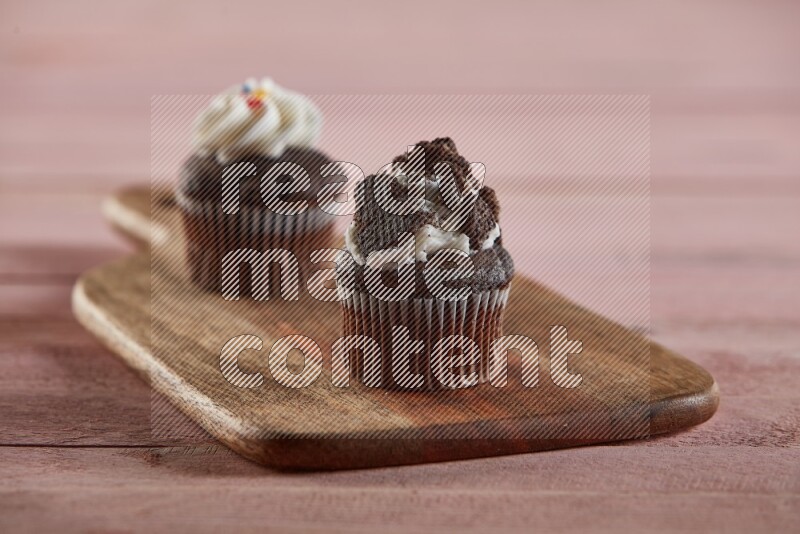Chocolate mini cupcake topped with oreo on a wooden board