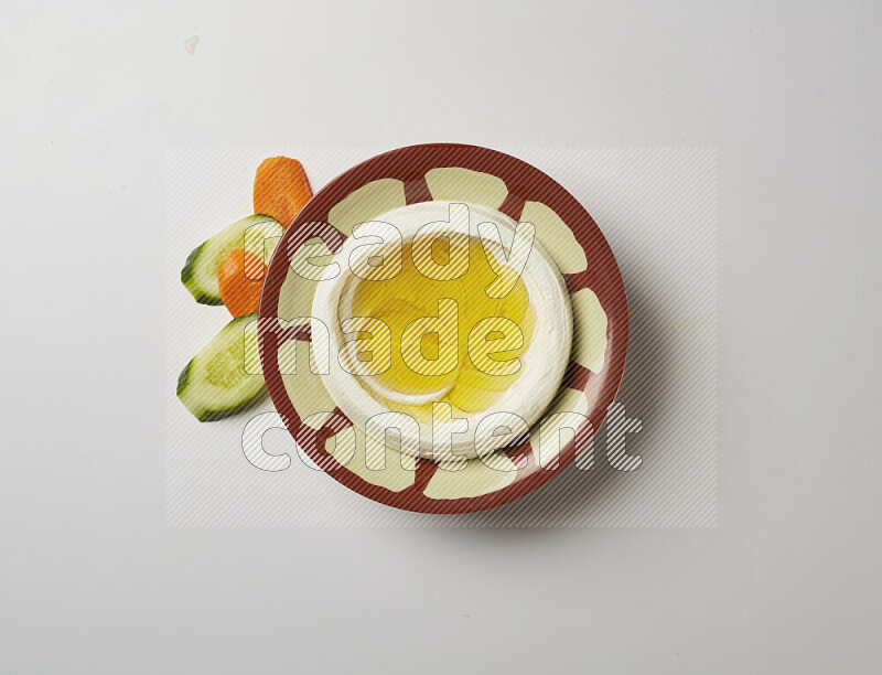 Lebnah garnished with olive oil in a traditional plate on a white background