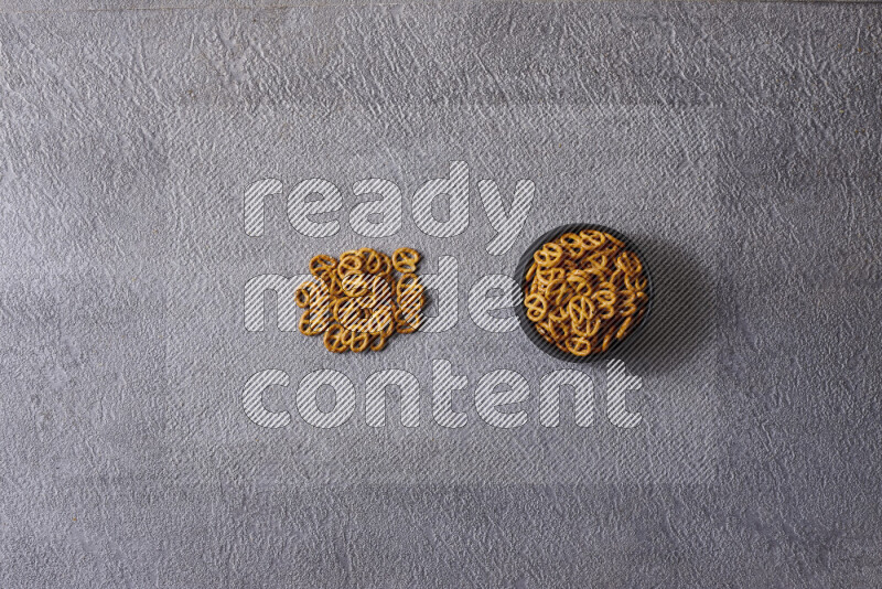 Assorted snacks in pottery bowls on grey background
