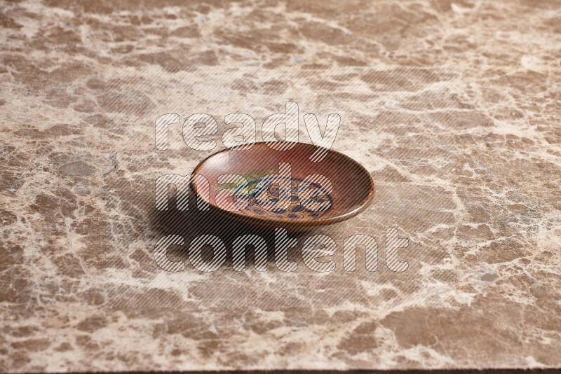 Decorative Pottery Plate on Beige Marble Flooring