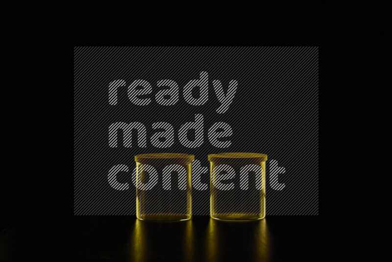 Glassware with rim light in yellow against black background