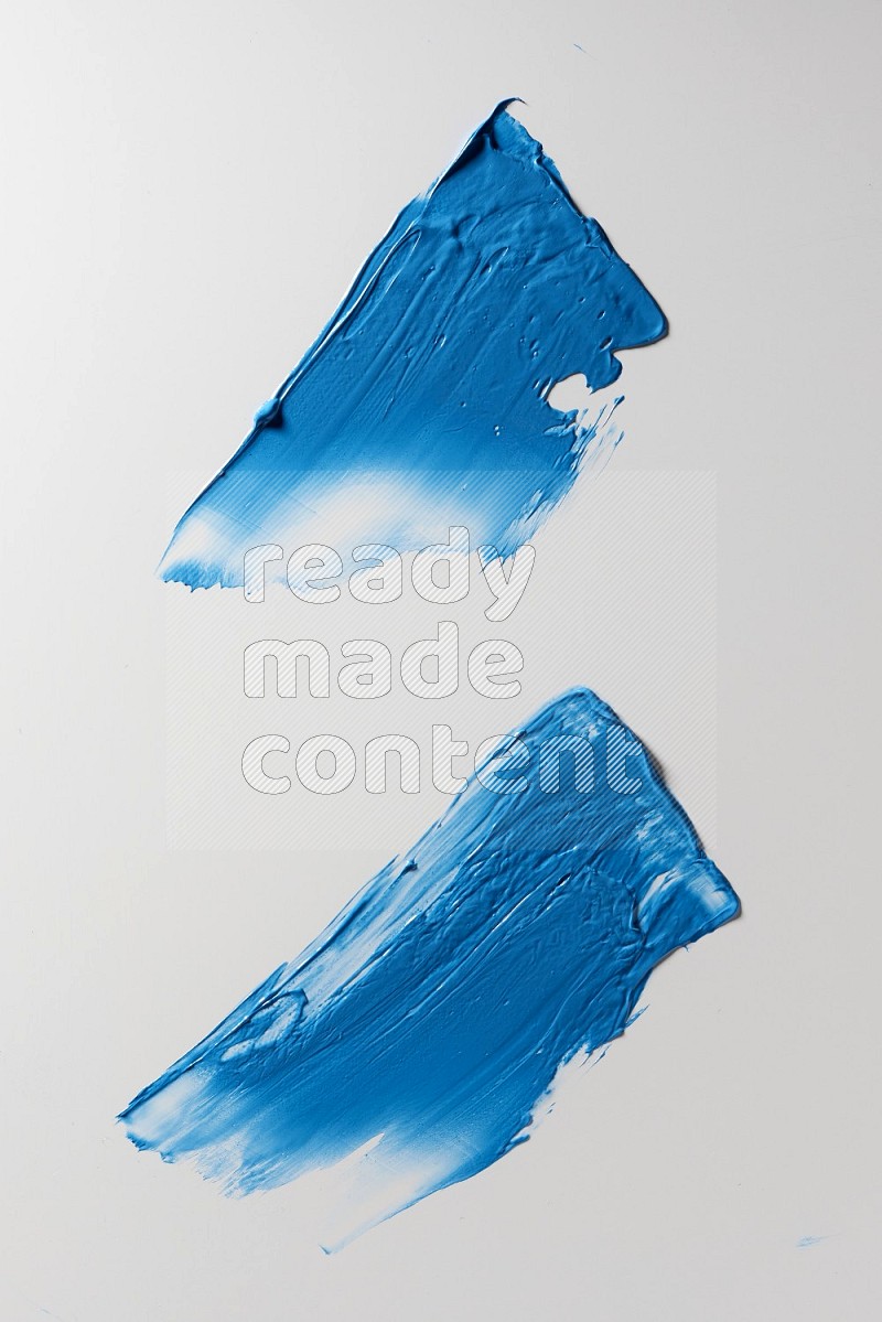 Blue painting knife strokes on white background