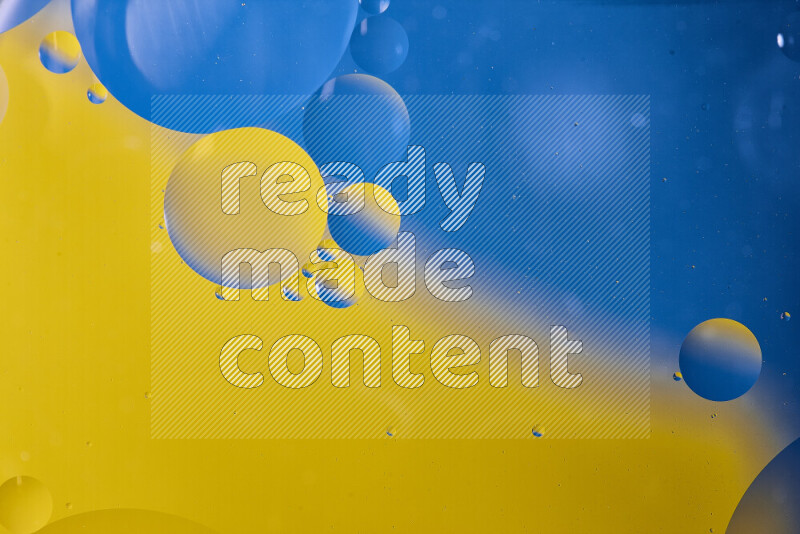 Close-ups of abstract oil bubbles on water surface in shades of blue and yellow
