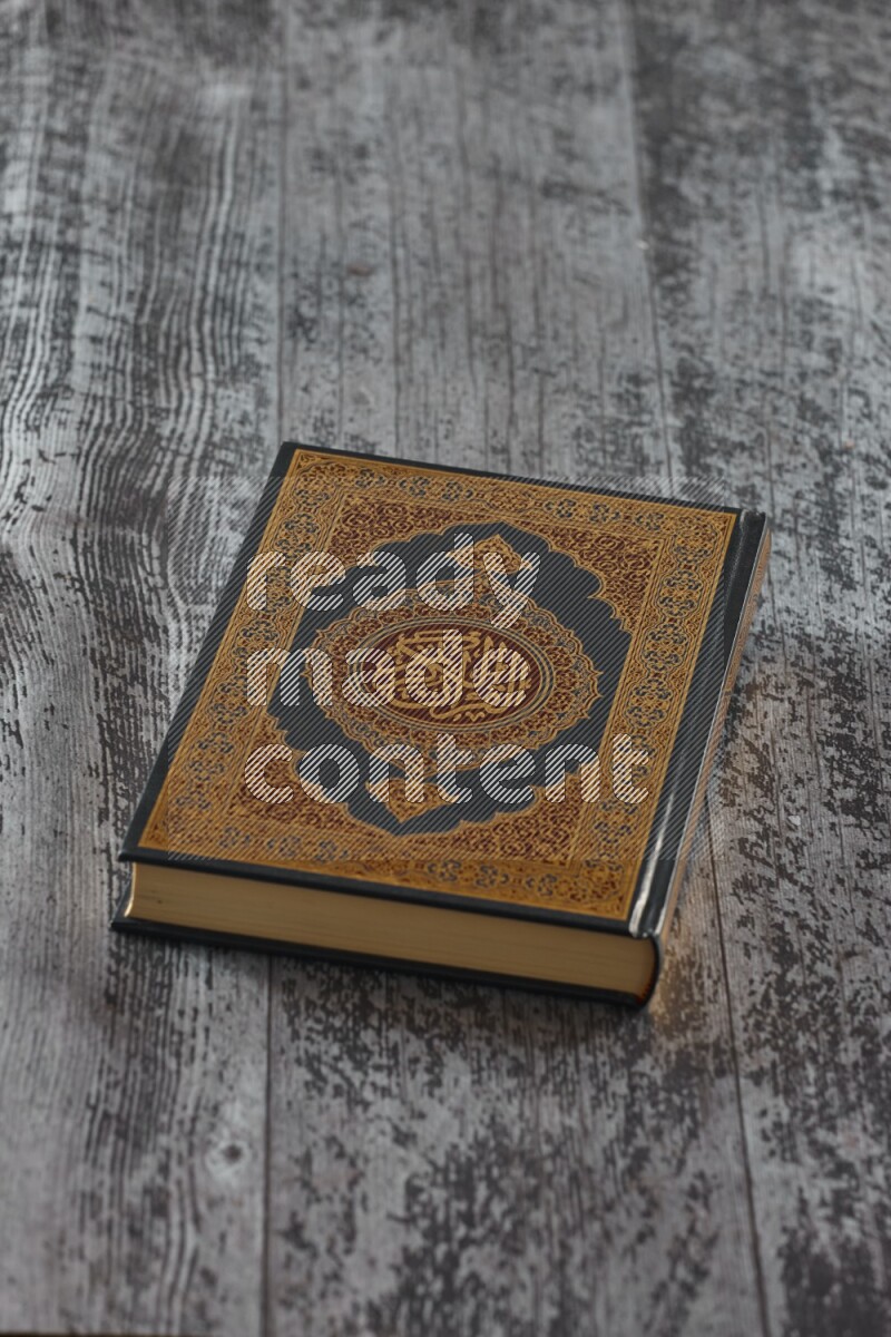 Quran with a prayer beads on wooden background