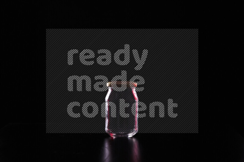 Glassware with rim light in red and white against black background