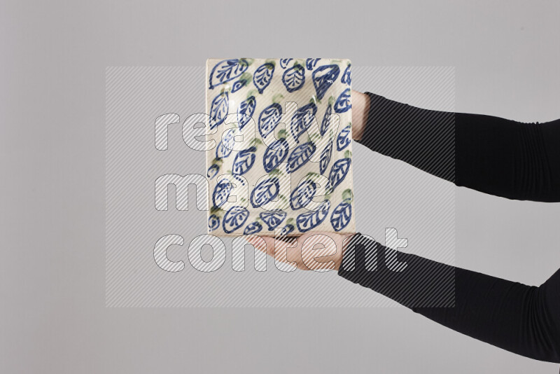 امرأة ترتدي عباءة سوداء تحمل أدوات فخارية مختلفة في أوضاع متعددة