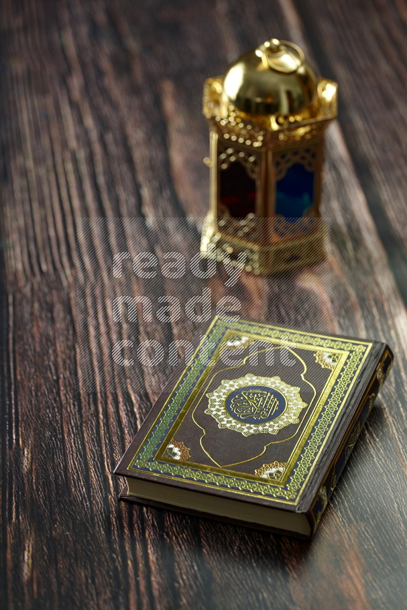 A golden lantern with different drinks, dates, nuts, prayer beads and quran on brown wooden background