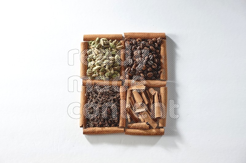 4 squares of cinnamon sticks full of coffee beans, cinnamon, cloves and cardamom on white flooring