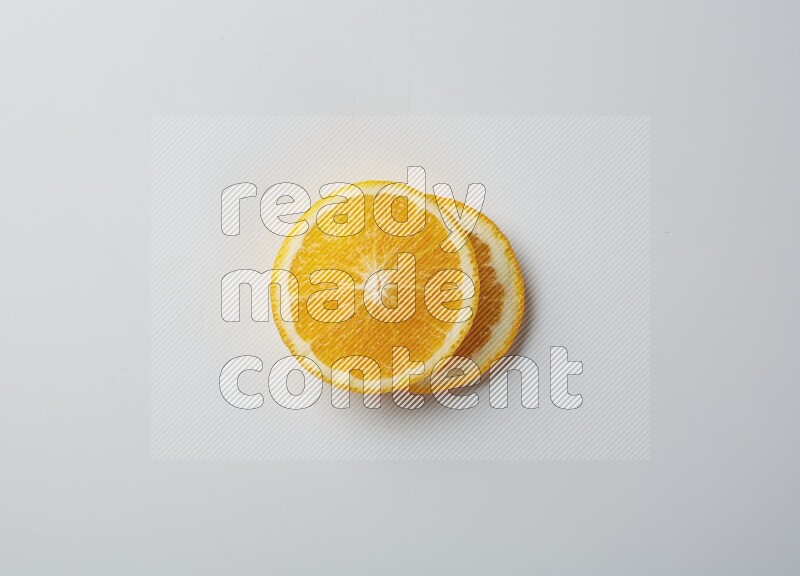 Two orange slices on white background