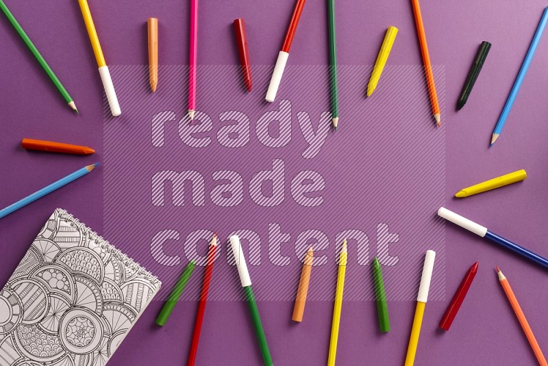 A coloring book with color pens on purple background (Back to school)