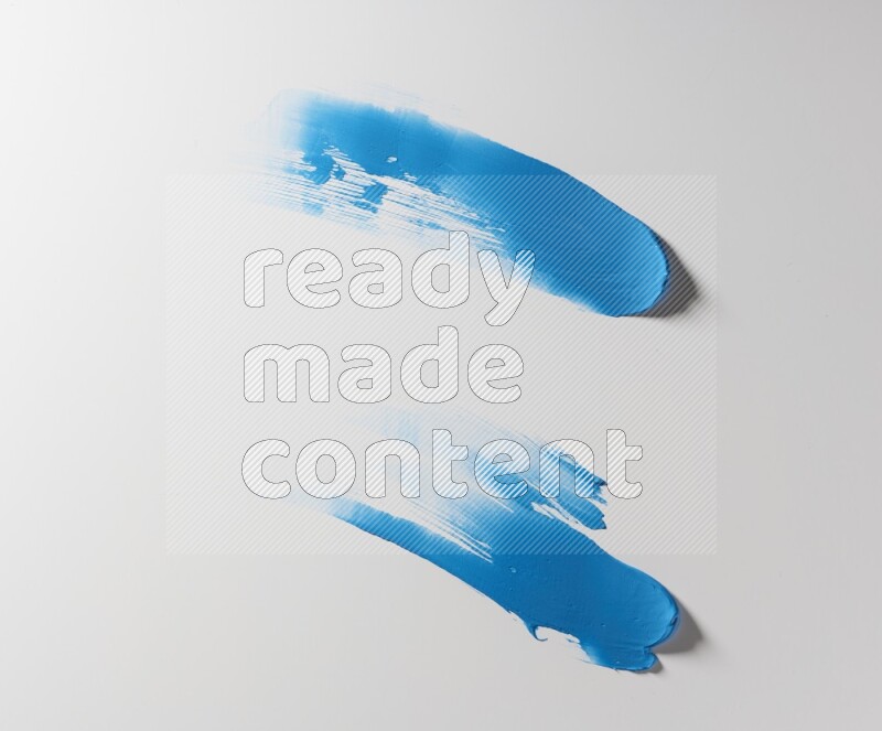 Blue curved painting knife strokes on white background