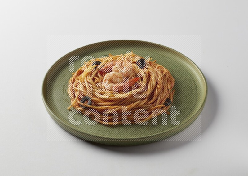 spaghetti pasta with red sauce on a green plate on a white background