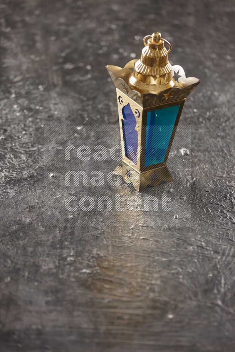 A lantern placed on a textured black background