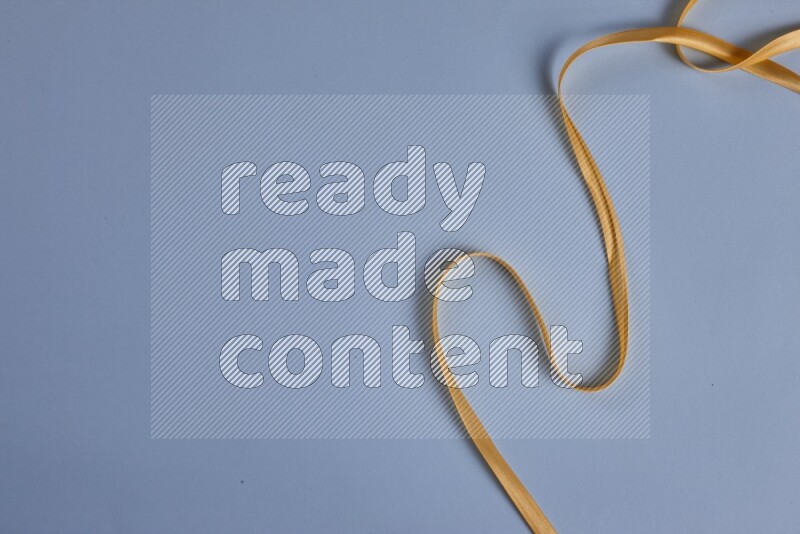 A yellow collection of sewing and tailoring tools arranged on a blue background