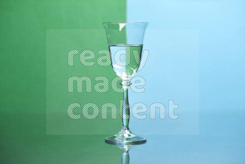 The image features a clear glassware filled with water, set against green and light blue background