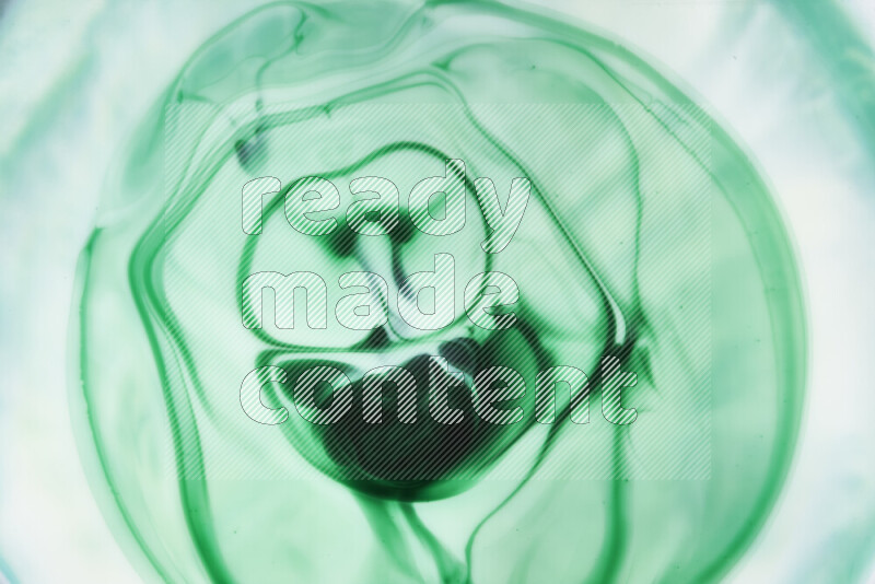 A close-up of abstract swirling patterns in green gradients