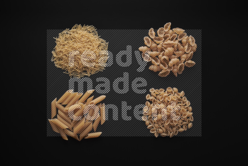 Different pasta types in bunches on black background
