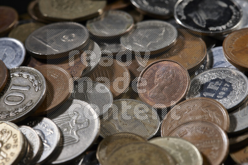 A close-ups of random old coins on black background