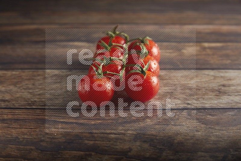 Red cherry tomato vein on a textured wooden background 45 degree