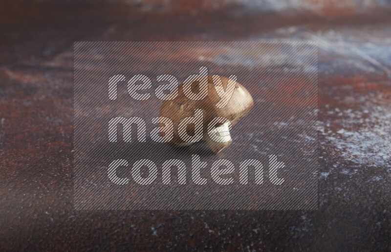 45 degre cremini  mushrooms on a textured reddish rustic metal background