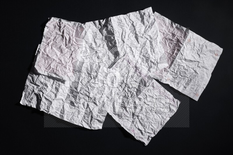 Crumpled notebook sheet on black background