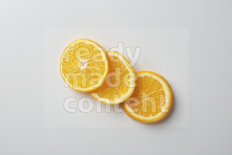 Three orange slices on a white background