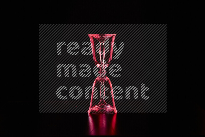 Glassware with rim light in red against black background