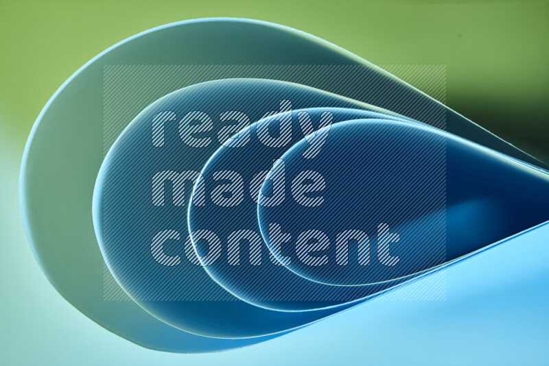 An abstract art of paper folded into smooth curves in green and blue gradients