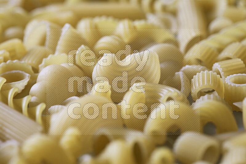 Different pasta types on light blue background