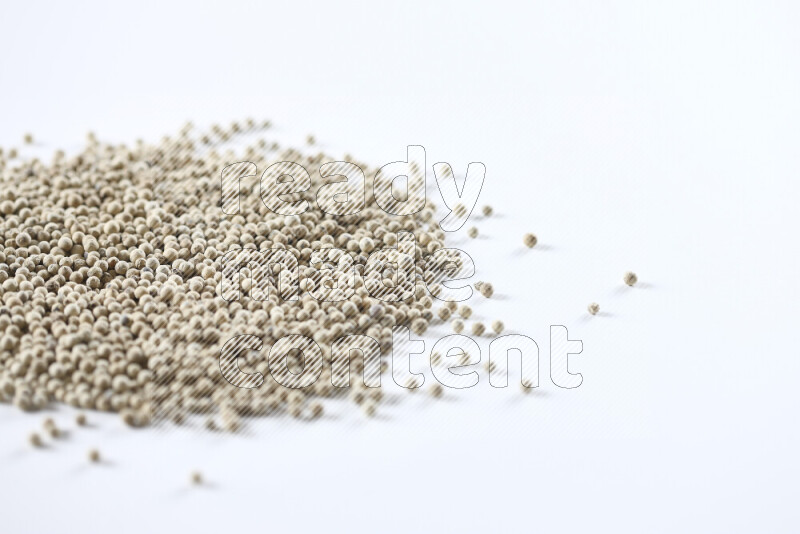 White pepper beads on white background