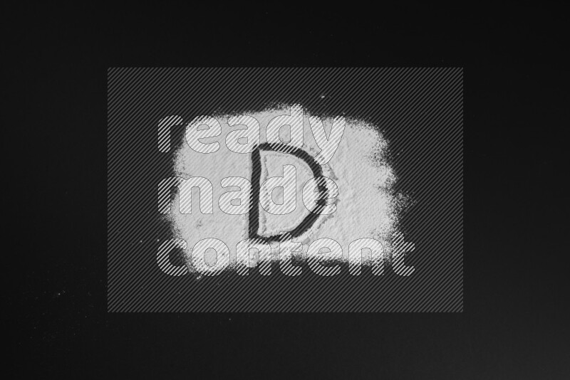 Alphabets written with powder on black background