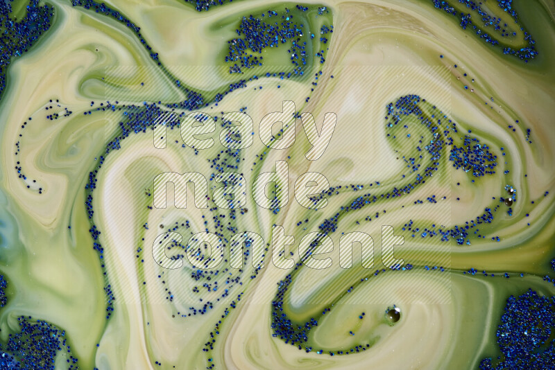 لقطة مقربة لبريق أزرق متلألئ منتشر على خلفية من اللون الأزرق والأخضر في حركات دائرية