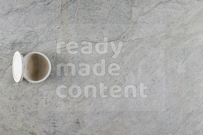 Top View Shot Of A Multicolored Pottery Cup On Grey Marble Flooring