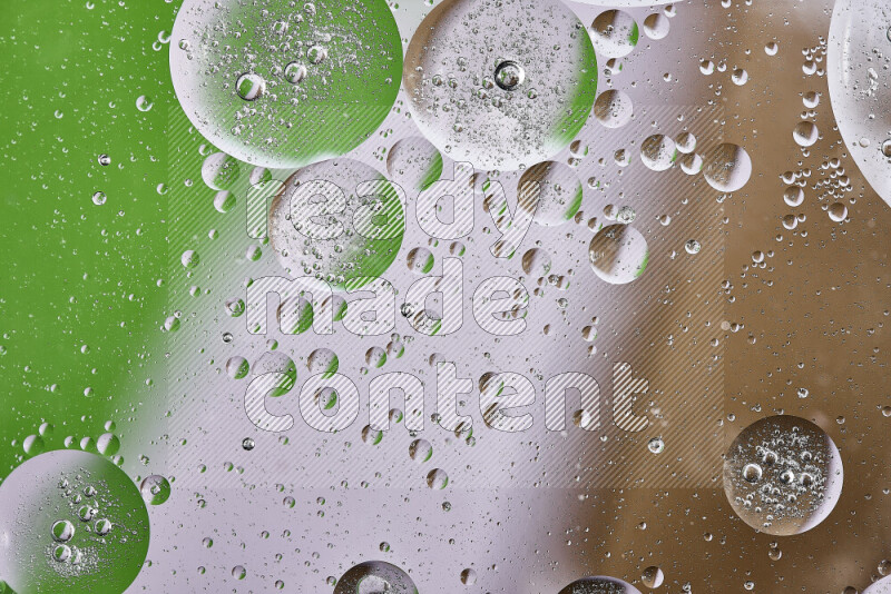 Close-ups of abstract oil bubbles on water surface in shades of brown, green and white