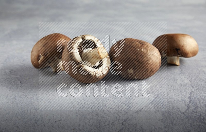 45 degre cremini  mushrooms on a textured light blue background