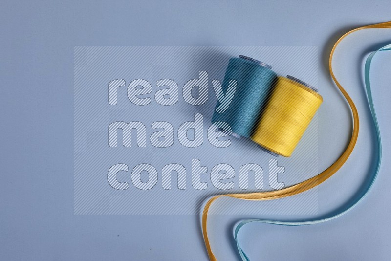 Yellow sewing supplies on blue background