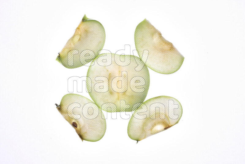 Apple slices on illuminated white background