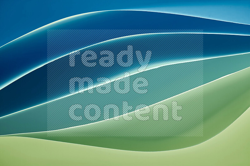 This image showcases an abstract paper art composition with paper curves in green and blue gradients created by colored light