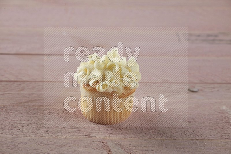Vanilla mini cupcake topped with white chocolate curls