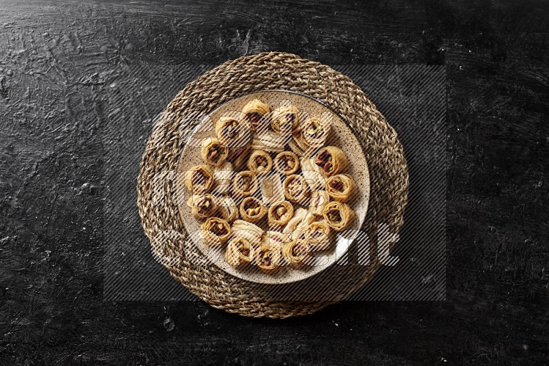 Oriental sweets in pottery plates in a dark setup