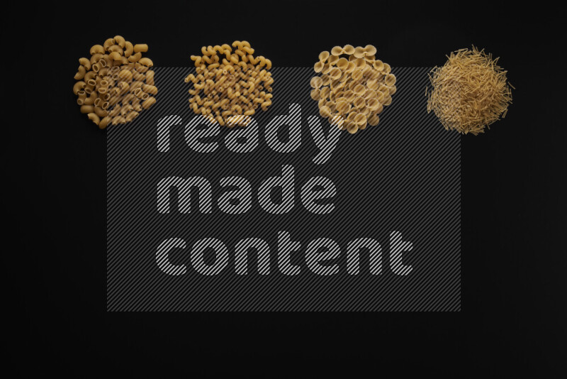 Different pasta types in 4 bunches on black background