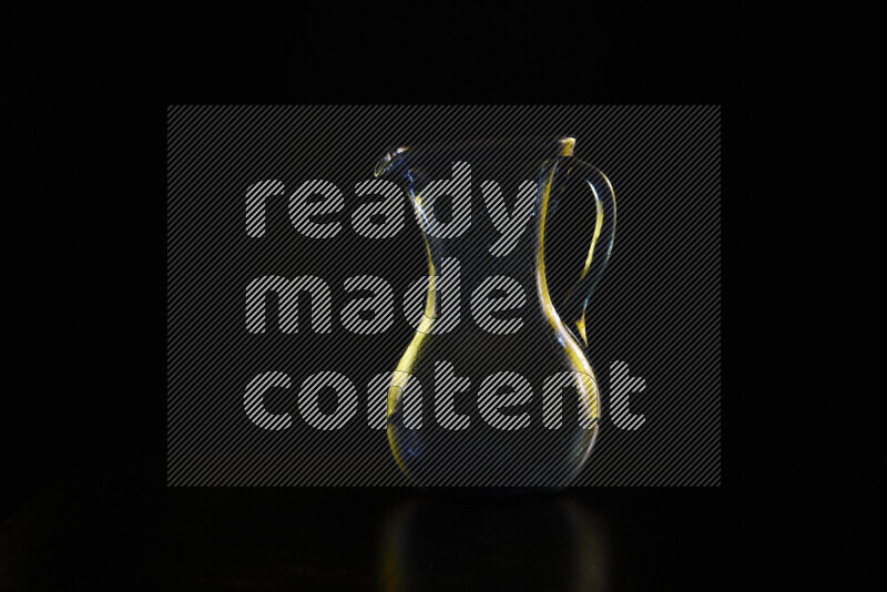 Glassware with rim light in yellow against black background