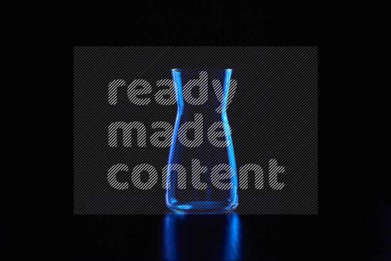 Glassware with rim light in blue against black background