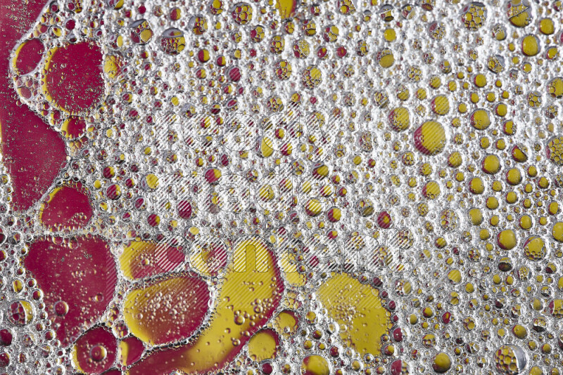 Close-ups of abstract soap bubbles and water droplets on pink and yellow background