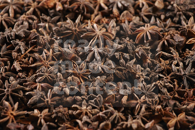 Star Anise fill the frame on black flooring