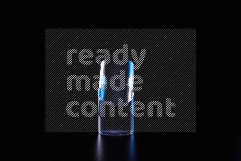 Glassware with rim light in blue and white against black background