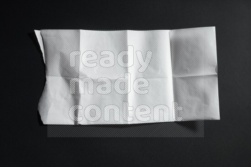 White paper sheet on black background